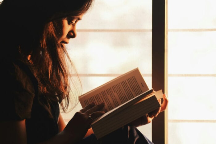Femme lisant un livre le soir © Pexels - Rahul Shah