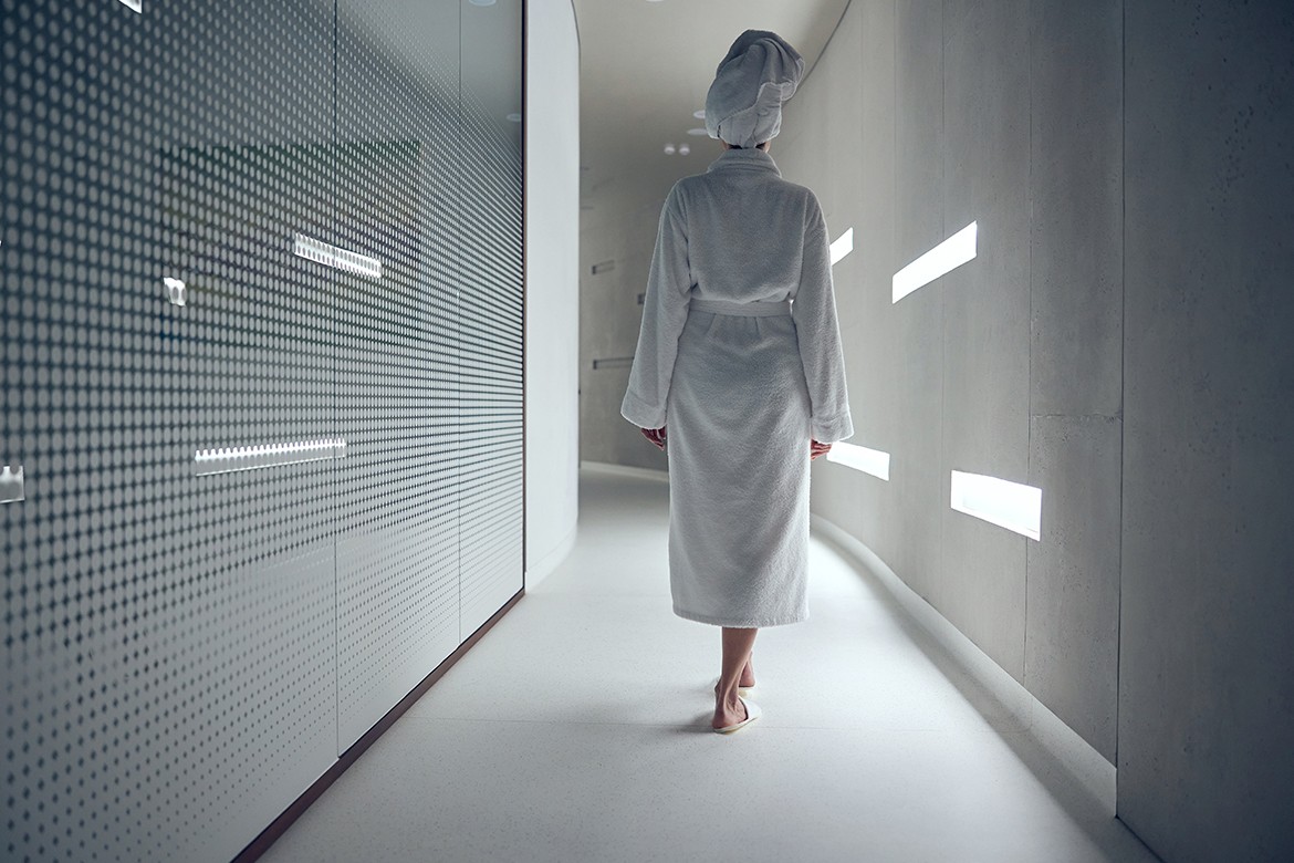 Femme en peignoir marchant dans un couloir